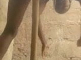wanita Afrika melancap dengan pemegang penyapu.